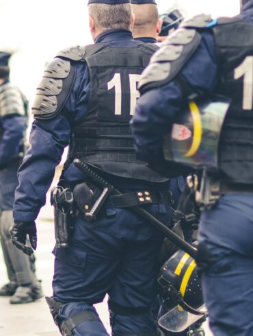 group of police officers walking during daytime