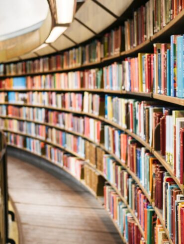 books on brown wooden shelf