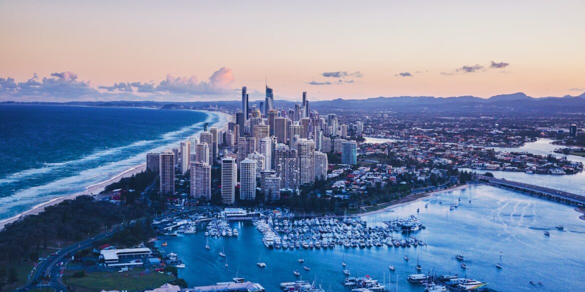 aerial view of city buildings near body of water during daytime
