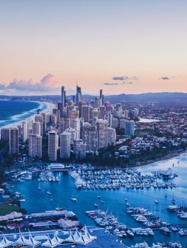 aerial view of city buildings near body of water during daytime