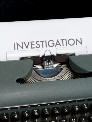 green and white typewriter on blue textile