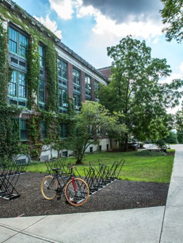 black bicycle parked in front of building