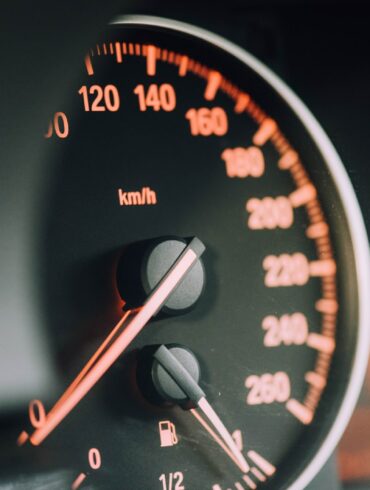 closeup photo of black analog speedometer