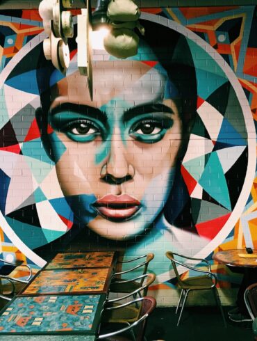 woman sitting near graffiti