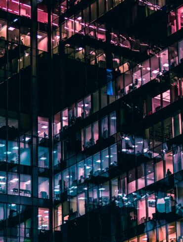 architectural photography of building with people in it during nighttime