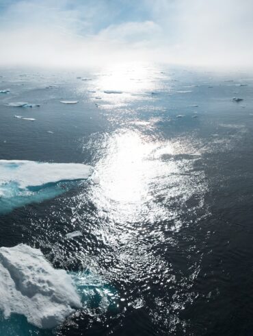 landscape and aerial photography of icebergs on body of water during daytime
