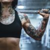 woman carrying barbell