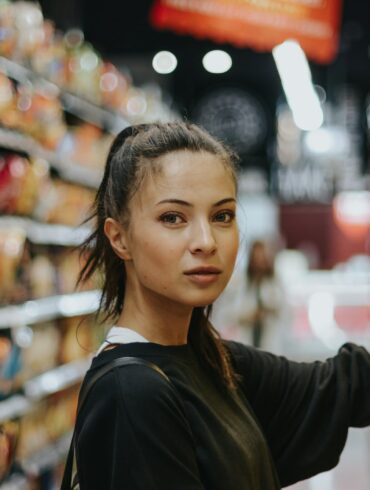 woman selecting packed food on gondola