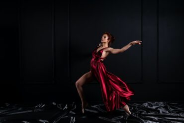 woman wearing red tank satin high slit dress