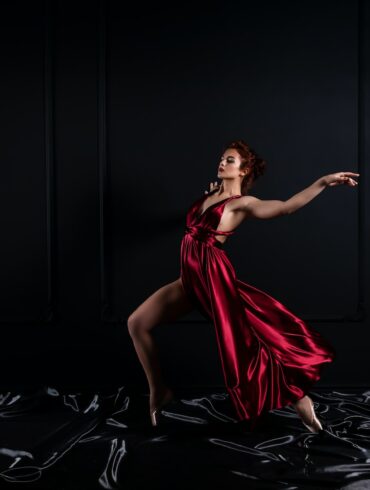 woman wearing red tank satin high slit dress