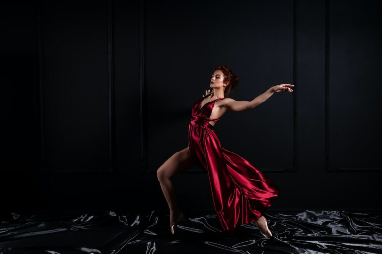 woman wearing red tank satin high slit dress