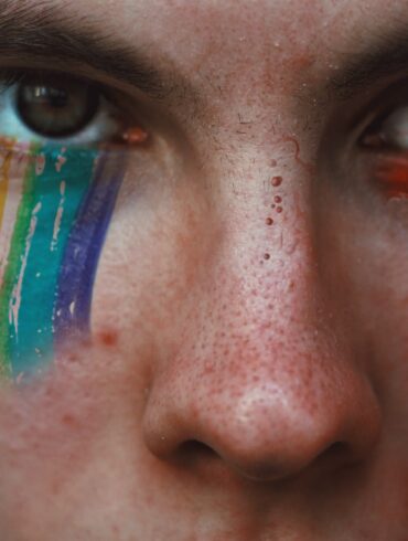 closeup photography of person with rainbow eyeshadow