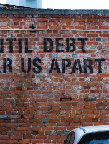 until debt tear us apart brick wall vandal