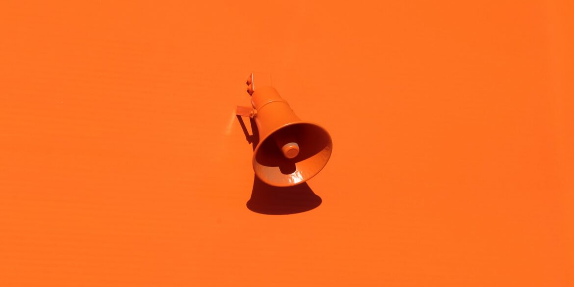 orange megaphone on orange wall