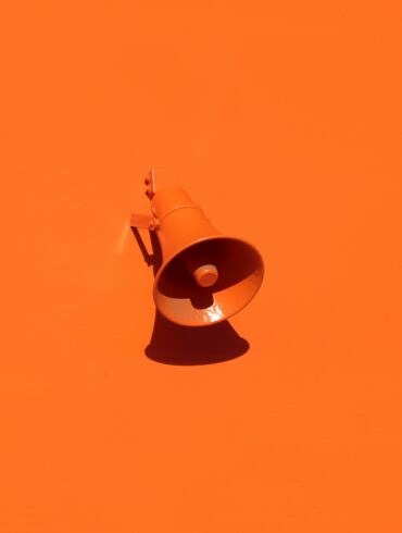 orange megaphone on orange wall
