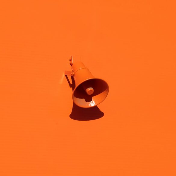 orange megaphone on orange wall