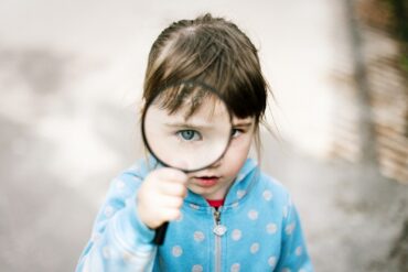 girl in blue and white polka dot jacket