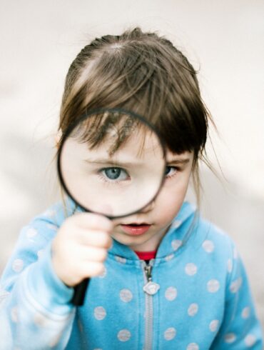 girl in blue and white polka dot jacket