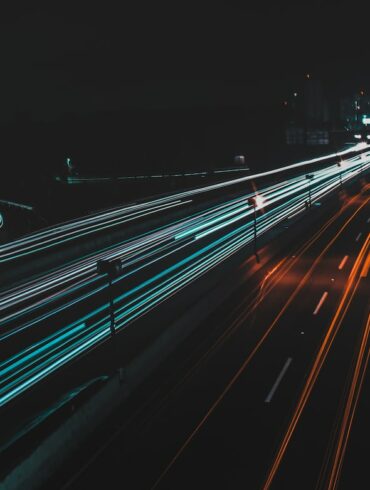 time lapse photography of lighted road at night
