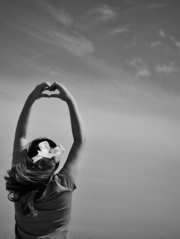 woman making heart shape on her hards