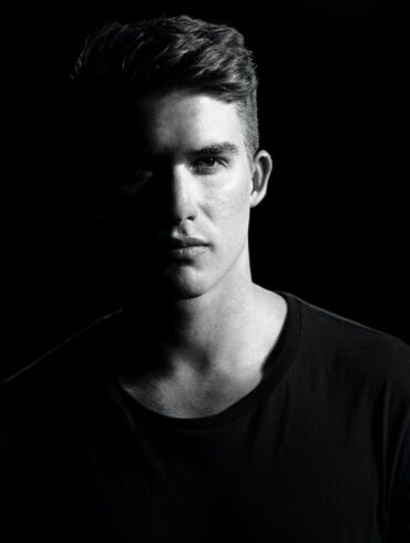 grayscale photography of man wearing shirt
