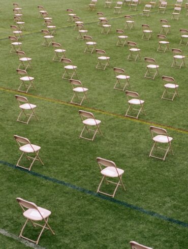 white folding chairs on green grass field