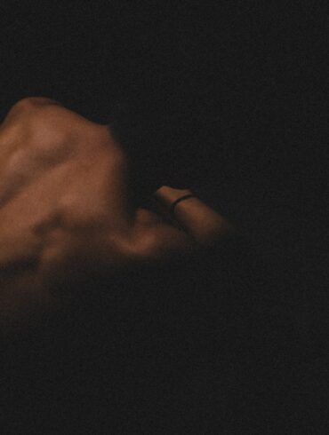 a hand holding a cell phone in the dark
