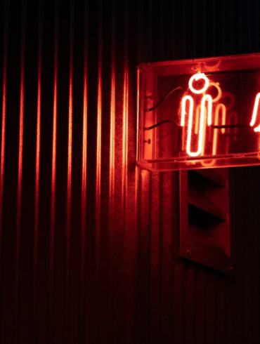 a red sign with a white symbol