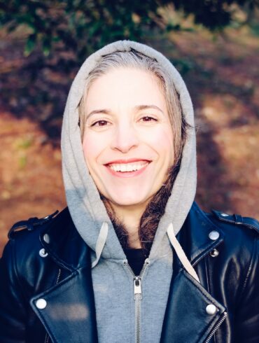 woman smiling near tree