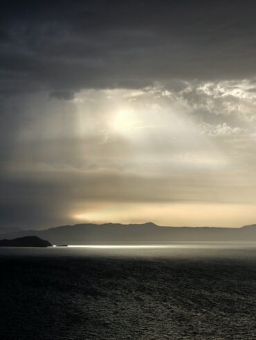 body of water under cloudy sky during daytime