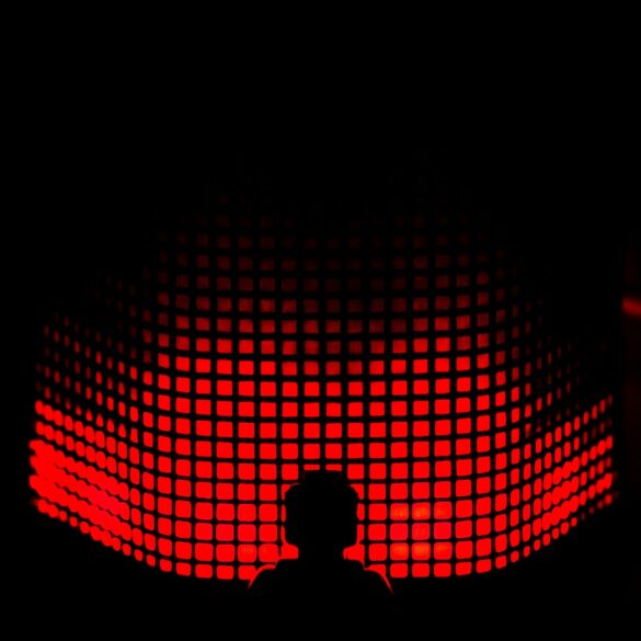 a person standing in front of a red light