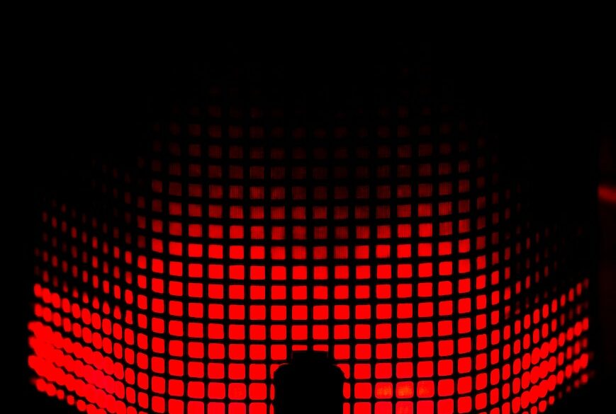 a person standing in front of a red light
