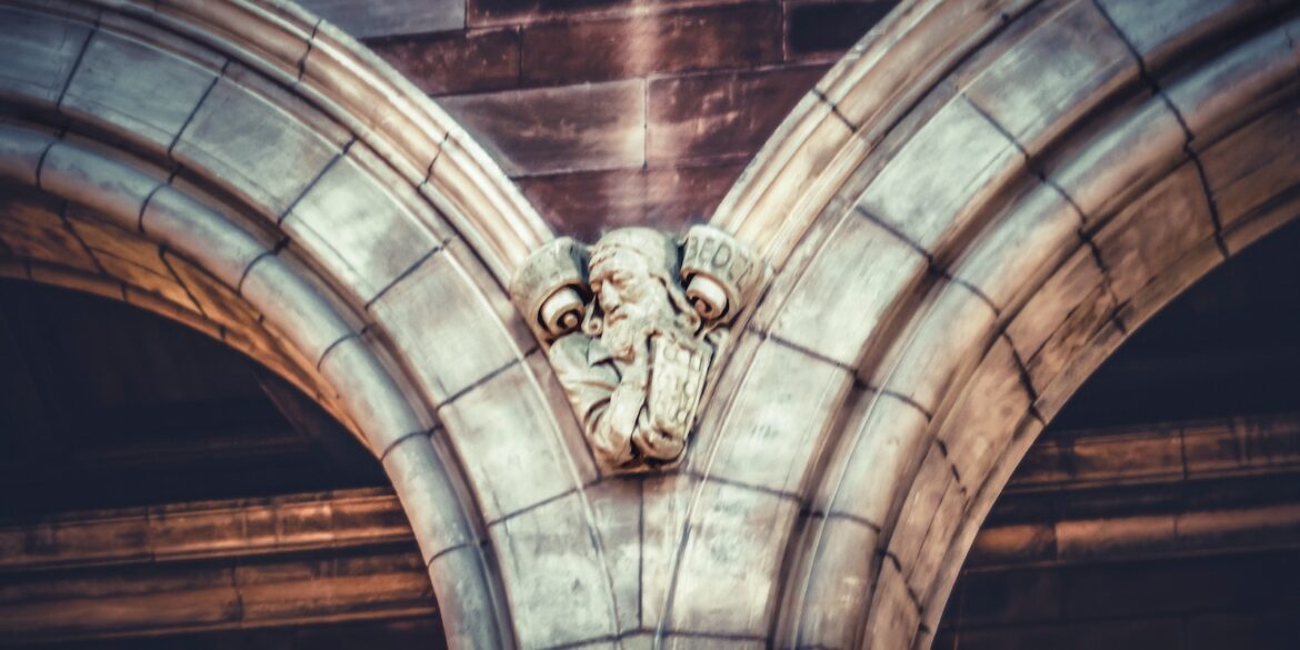 a gargoyle head on the side of a building