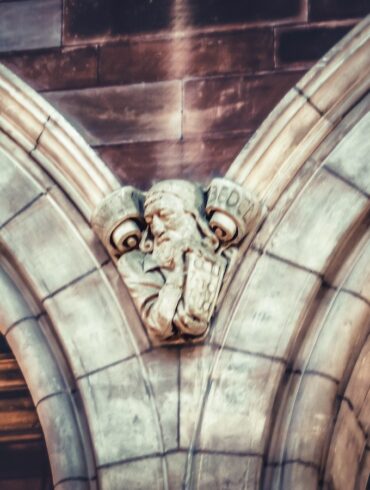 a gargoyle head on the side of a building