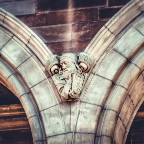 a gargoyle head on the side of a building