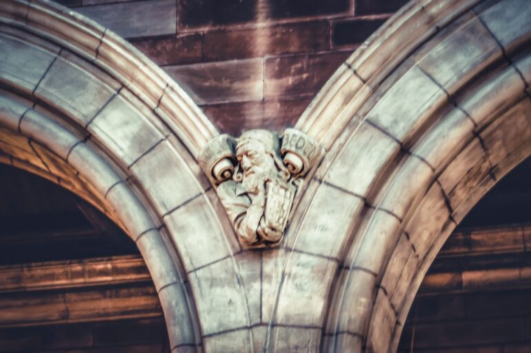 a gargoyle head on the side of a building