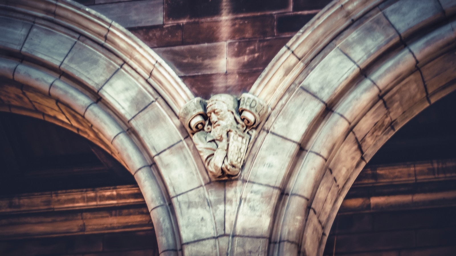 a gargoyle head on the side of a building