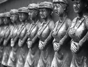 grayscale photo of man and woman statue