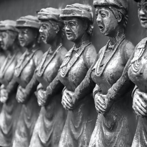 grayscale photo of man and woman statue