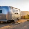 white and blue van on brown dirt road during daytime