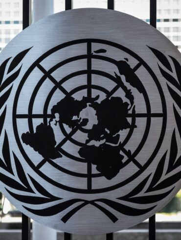 the united nations emblem is on display in front of a window