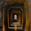 a hallway with arches and columns
