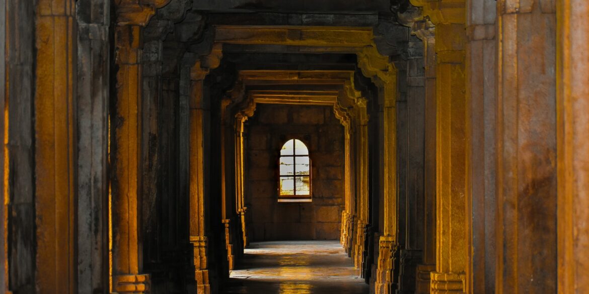 a hallway with arches and columns