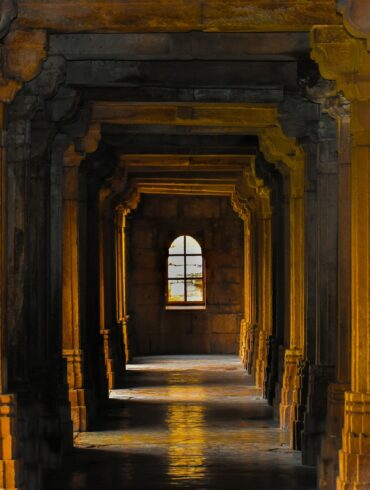 a hallway with arches and columns