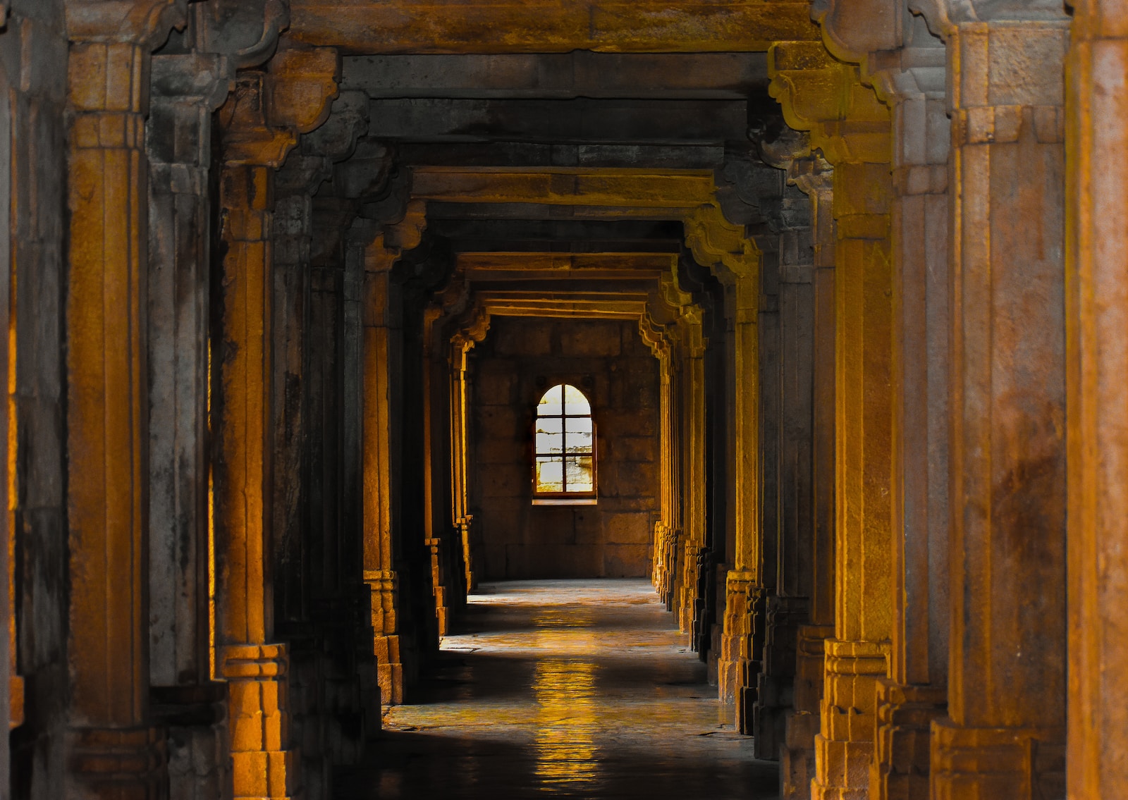 a hallway with arches and columns