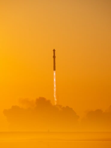 a rocket is flying through the air on a foggy day