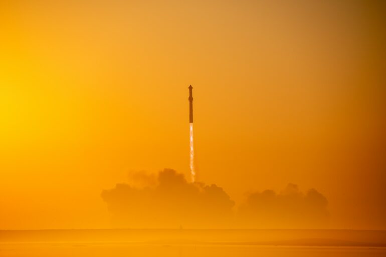 a rocket is flying through the air on a foggy day