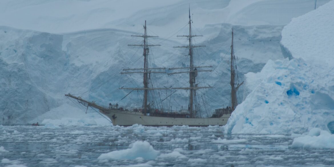 white galleon ship near glaciers