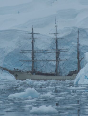white galleon ship near glaciers