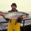 man carrying silver fish